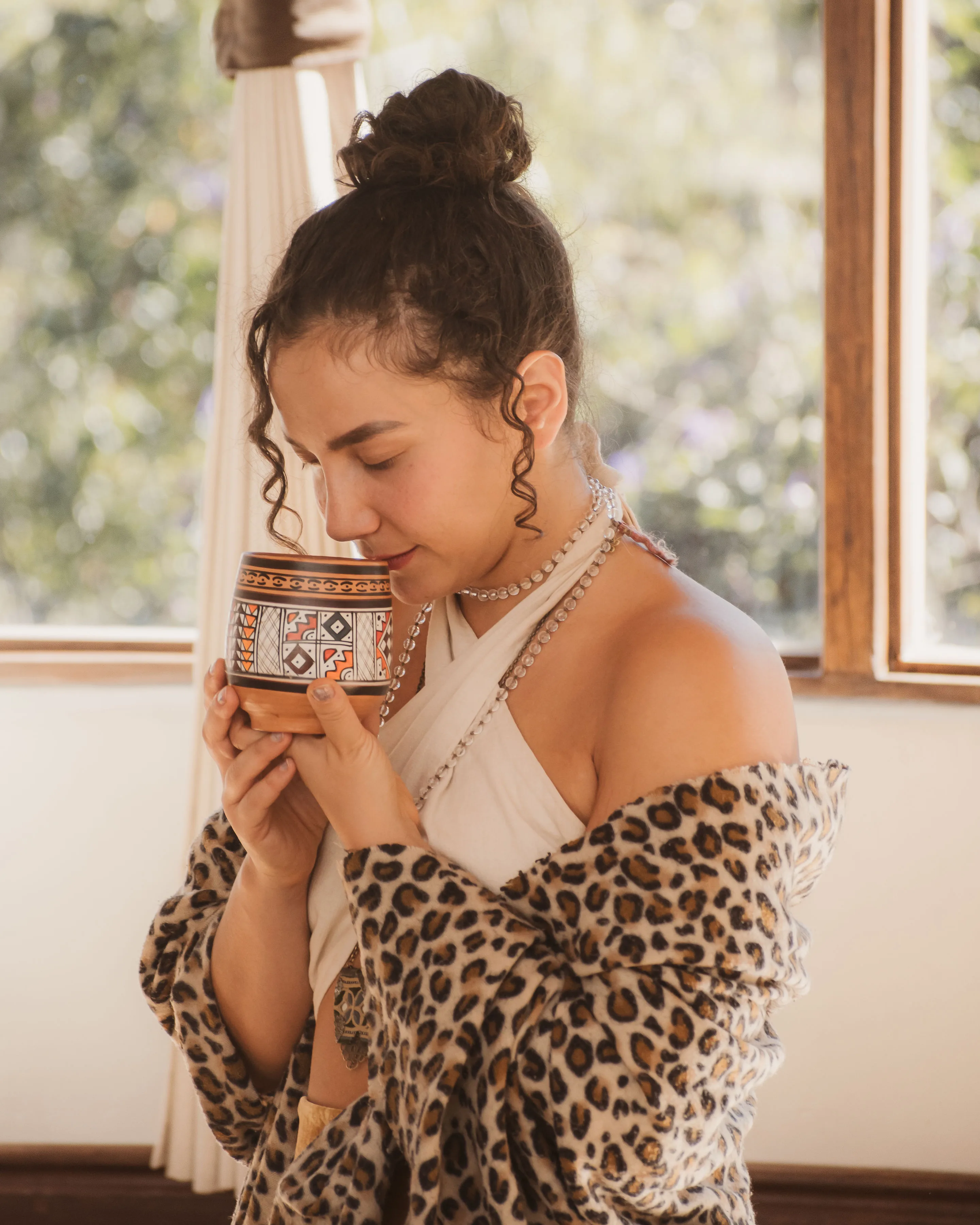 Paras in quiet ceremony with a cup of plant medicine
