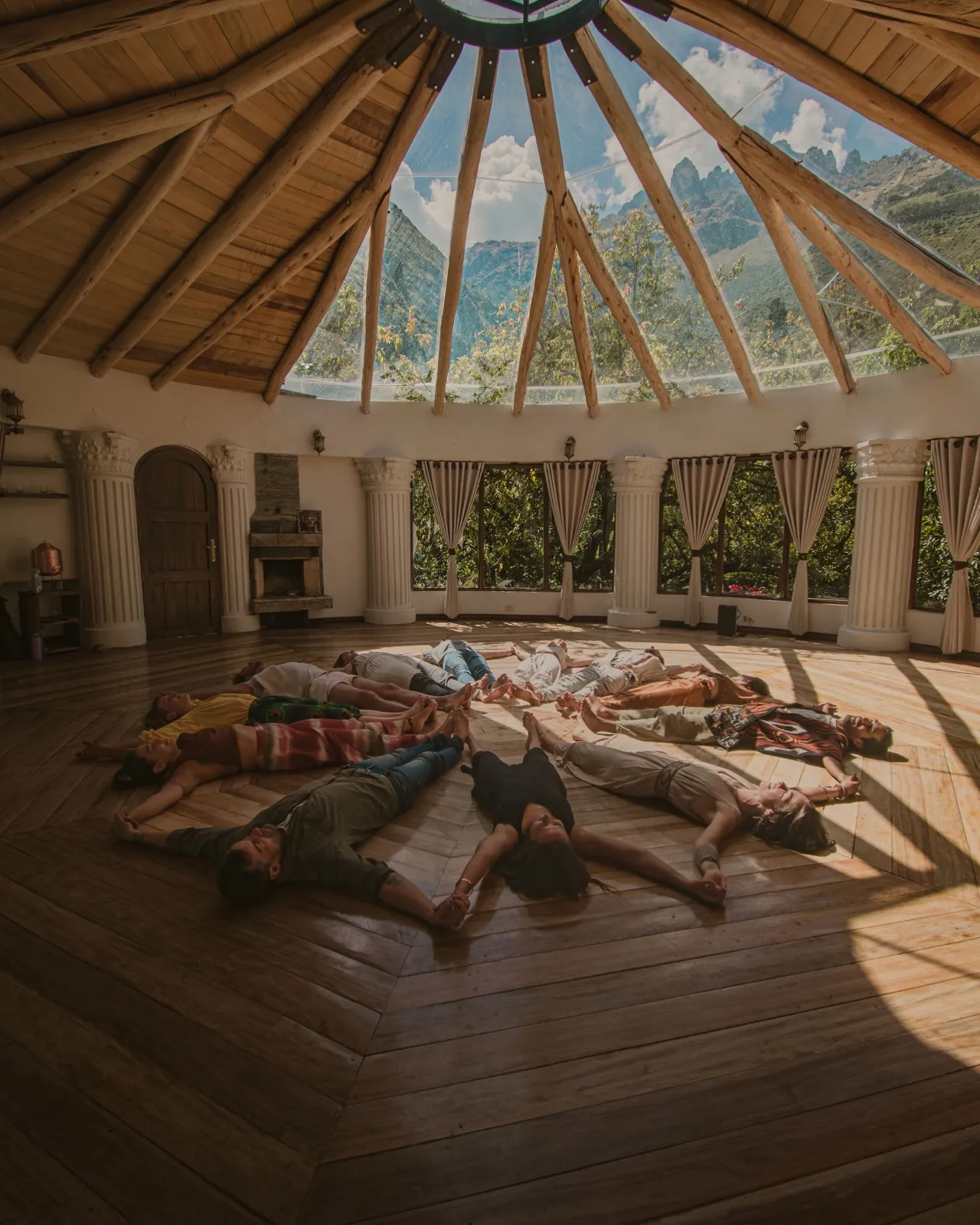 A group resting together in a mandala on the floor of the sunlit dome